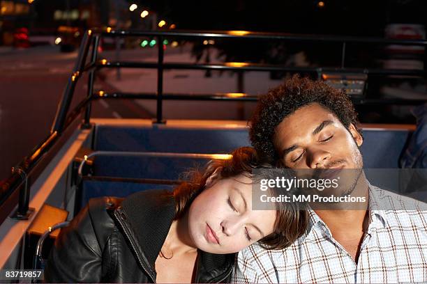 young couple asleep on open top bus - double decker bus stock pictures, royalty-free photos & images