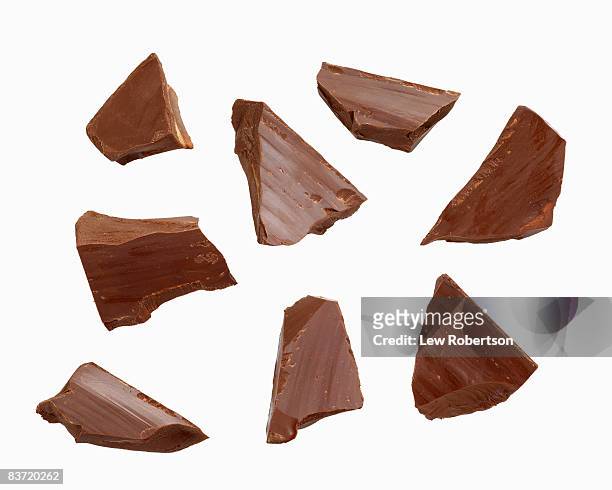 dark chocolate pieces on white - chocolate stock pictures, royalty-free photos & images