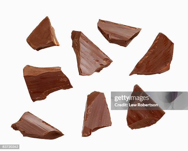 dark chocolate pieces on white - chocolate photos - fotografias e filmes do acervo