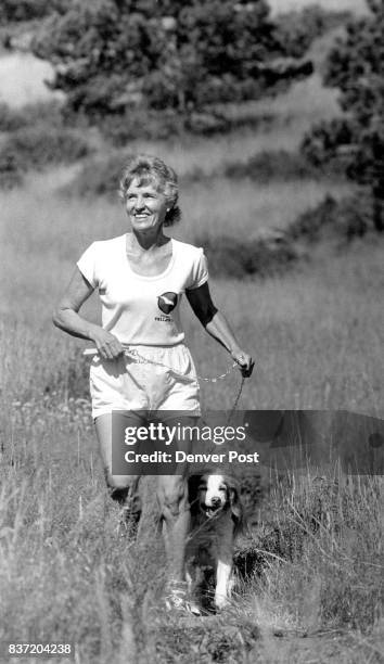 Jane Siefert runs daily with her dog Daisy, a Brittany Spaniel, near her home in Boulder Part of their run is on a trail in a field near Flatirons....