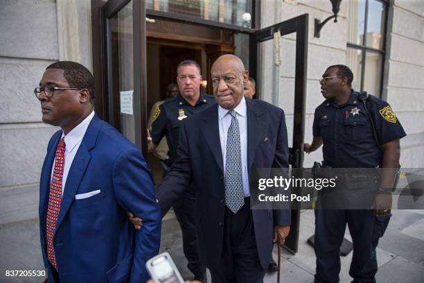 Bill Cosby, center, leaves the Montgomery County Courthouse, led by Andrew Wyatt, left, and behind his new legal team, after details of the new trial...