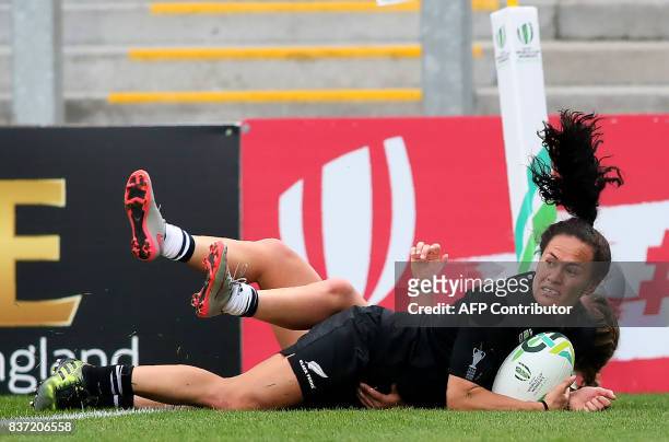 New Zealand's wing Portia Woodman scores a try during the Women's Rugby World Cup 2017 semi-final match between New Zealand and USA at The Kingspan...