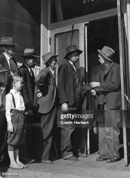 Group of unemployed men queuing for clothing at a relief depot in Salem, Virginia, USA, circa 1935.