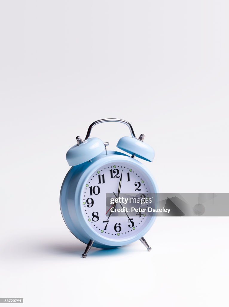 Blue alarm clock on white background