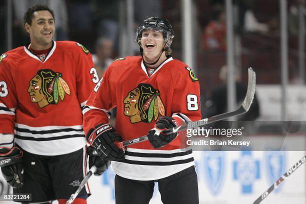 Patrick Kane and Dustin Byfuglien of the Chicago Blackhawks joke around during the shoot around before the game against the Boston Bruins at the...