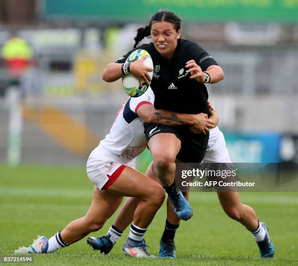 New Zealand's centre Stacey Waaka is tackled by US prop Tiffany Faaee and US fly-half Kimber Rozier during the Women's Rugby World Cup 2017...