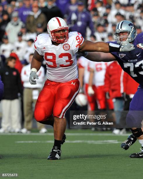 Nose takle Ndamukong Suh of the Nebraska Cornhuskers brakes through the block of offensive guard Gerard Spexarth of the Kansas State Wildcats during...