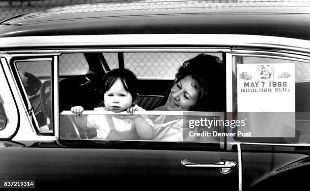 On the right is Darline Schossow the little girl is her grand daughter, Tonia Martin who is one year old they are in a 1958 Ford outside of Niwot...