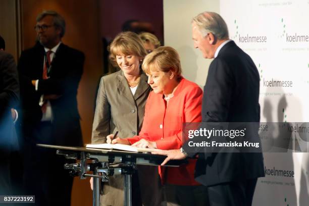 German Chancellor Angela Merkel , Henriette Reker and Gerald Boese during the opening of the Gamescom 2017 gaming trade fair during the media day on...