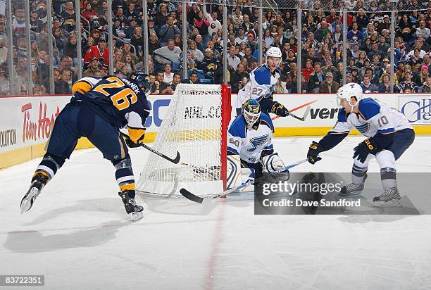 Goaltender Chris Mason, Andy McDonald and Alex Pietrangelo of the St.Louis Blues defend the play against Thomas Vanek of the Buffalo Sabres during...