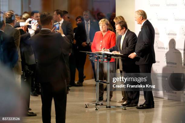 German Chancellor Angela Merkel , Henriette Reker, Armin Laschet and Gerald Boese during the opening of the Gamescom 2017 gaming trade fair during...