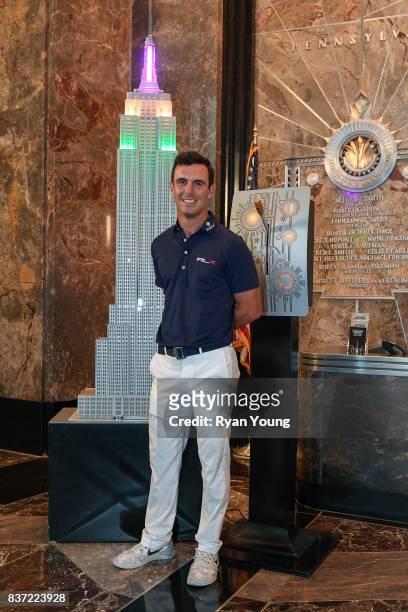 Billy Horschel flips the switch to light up the Empire State Building in FedEx colors during a preview media tour for THE NORTHERN TRUST on August...