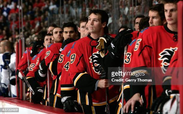 Wayne Primeau and teammates of the Calgary Flames stand on the bench during the pre game ceremony against the Toronto Maple Leafs on November 11,...