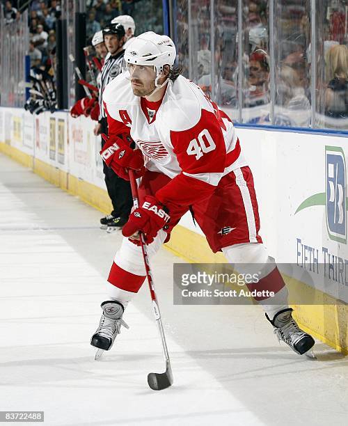 Henrik Zetterberg of the Detroit Red Wings passes the puck against the Tampa Bay Lightning at the St. Pete Times Forum on November 13, 2008 in Tampa,...