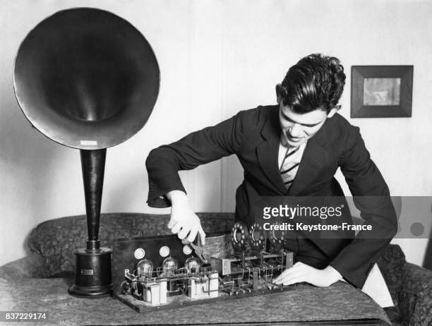 Un jeune homme examine un équipement radiophonique.