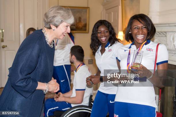 British Prime Minister Theresa May speaks to Perri Shakes-Drayton and Asha Philip a reception for who competed in the World Athletics Championships...