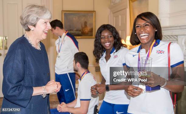 British Prime Minister Theresa May speaks to Perri Shakes-Drayton and Asha Philip a reception for who competed in the World Athletics Championships...