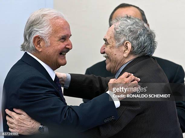 Mexican writer Carlos Fuentes is congratulated by Colombian writer Gabriel Garcia Marquez during a celebration for his 80th birthday in Mexico City,...