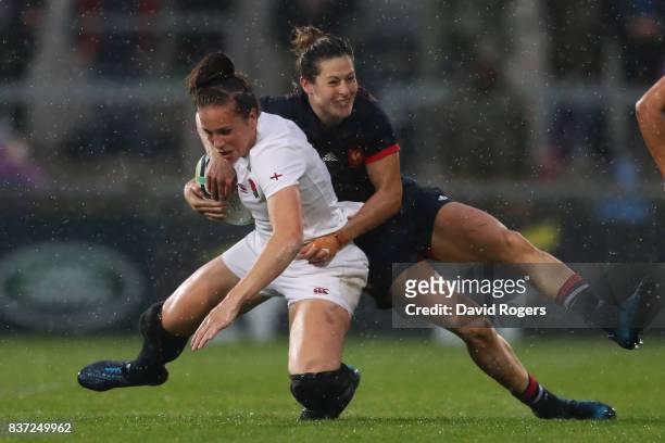 Emily Scarratt of England is tackled by Caroline Ladagnous during the Women's Rugby World Cup 2017 Semi Final match between England and France at the...