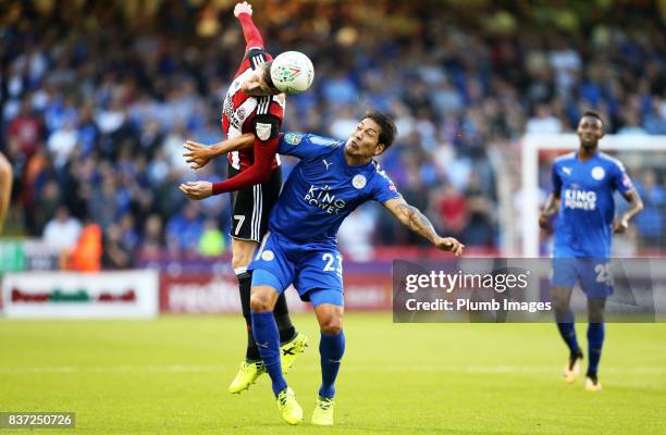 Leonardo Ulloa of Leicester City in action with John Lundstram of Sheffield United during the Carabao Cup Second Round tie between Sheffield United...