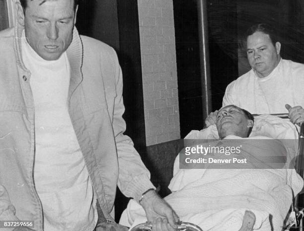 Cecil L. Phillips Is Wheeled Into Denver General Hospital Bob Streeter, ambulance driver, right, and Kenneth Edwards, attendant, move stretcher....
