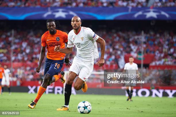 Steven N'Zonzi of Sevilla FC being followed by Emmanuel Adebayor of Istanbul Basaksehir during the UEFA Champions League Qualifying Play-Offs round...