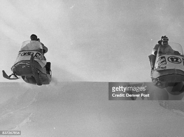 Two Ski-Doos race over a crest at 35 m.p.h. In the snow mobile at the left is Bill Nation of Hotchkiss, Colo., and, at the right, Dave Watson of...