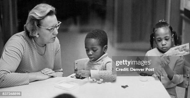 Teacher Thera Preston discusses project with Raymond Williams and Elaine Grant Credit: Denver Post