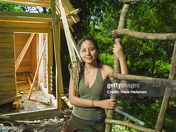 portrait of woman in front of house in forest - ヒリトラ ストックフォトと画像