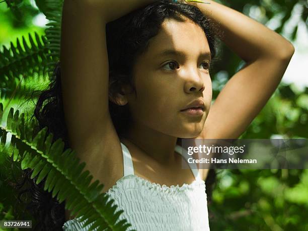 portrait of young girl in ferns, shadows on face - ヒリトラ ストックフォトと画像