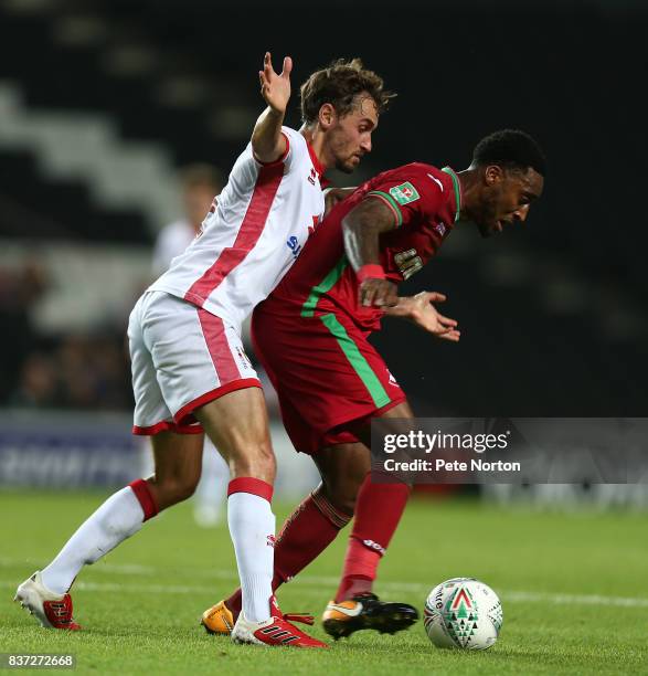 Leroy Fer of Swansea City controls the ball under pressure from Ed Upson of Milton Keynes Dons during the Carabao Cup Second Round match between...