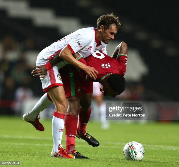 Leroy Fer of Swansea City contests the ball with Ed Upson of Milton Keynes Dons during the Carabao Cup Second Round match between Milton Keynes Dons...