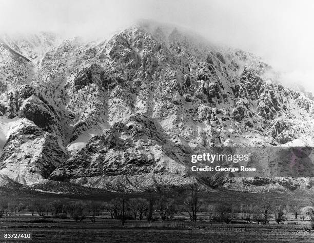 California's Eastern High Sierra mountains are covered with a heavy snowfall viewed in this 1990 Bishop, California, winter landscape photo.