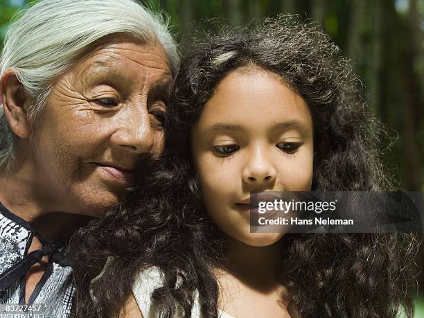 grandmother and granddaughter in garden - ヒリトラ ストックフォトと画像