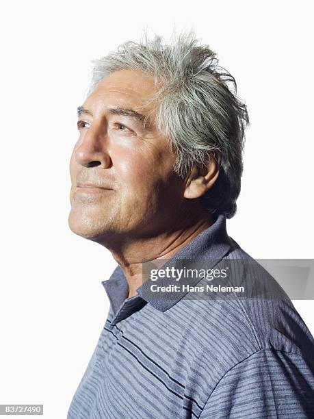 portrait of mature man looking to the distance - portrait white background looking away stockfoto's en -beelden