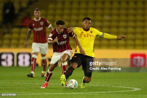 Troy Deeney of Watford tackles Freddie Hinds of Bristol City during the Carabao Cup Second Round match between Watford and Bristol City at Vicarage...