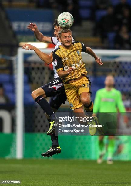 Sheffield Wednesday's Almen Abdi beats Bolton Wanderers' Will Buckley in the air during the Carabao Cup Second Round match between Bolton Wanderers...