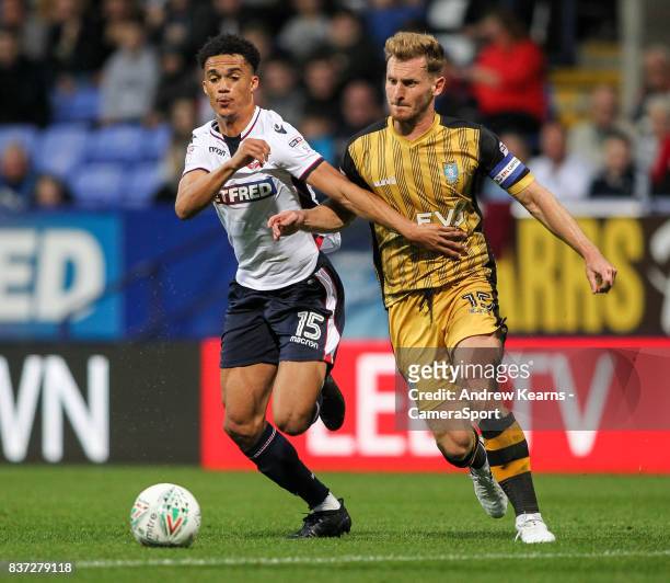 Bolton Wanderers' Antonee Robinson competing with Sheffield Wednesday's Tom Lees during the Carabao Cup Second Round match between Bolton Wanderers...