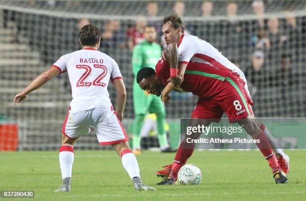 Leroy Fer of Swansea City is challenged by Ed Upson of MK Donsduring the Carabao Cup Second Round match between MK Dons and Swansea City at StadiumMK...