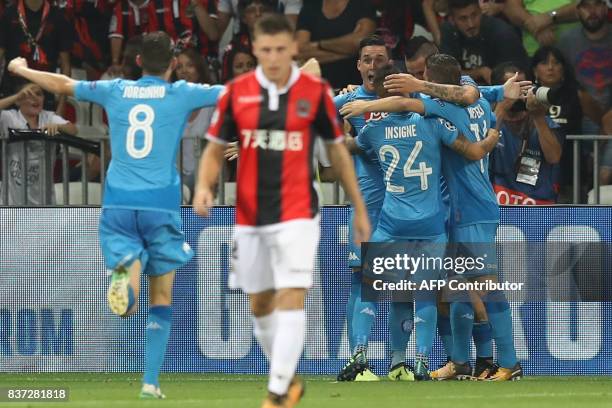 Napoli's Spanish striker Jose Maria Callejon celebrates with teammates after scoring a goal during the UEFA Champions League play-off football match...