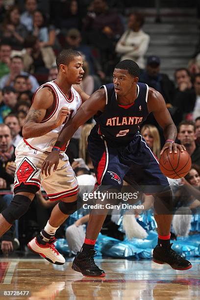 Joe Johnson of the Atlanta Hawks looks to maneuver against Derrick Rose of the Chicago Bulls during the game at the United Center on November 11,...