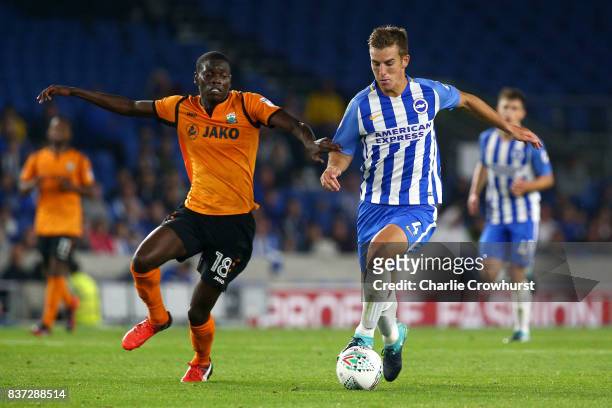 Wesley Fonguck of Barnet and Uwe Hunemeier of Brighton and Hove Albion battle for possession during the Carabao Cup Second Round match between...