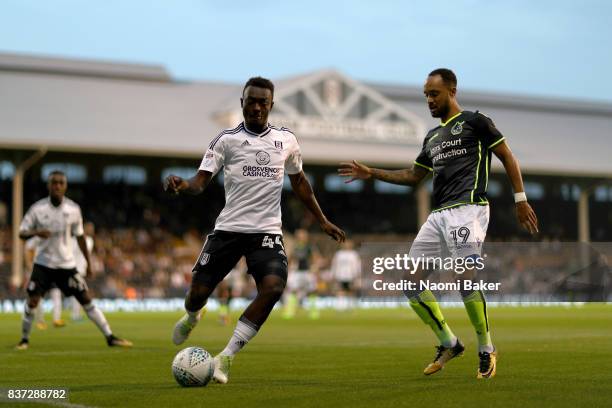 Ibrahima Cisse of Fulham holds off Byron Moore of Bristol Rovers during the Carabao Cup Second Round match between Fulham and Bristol Rovers at...