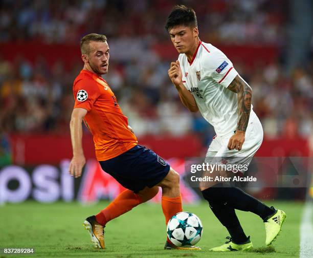 Joaquin Correa of Sevilla FC being followed by Edin Visca of Istanbul Basaksehir during the UEFA Champions League Qualifying Play-Offs round second...