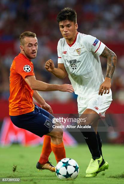 Joaquin Correa of Sevilla FC being followed by Edin Visca of Istanbul Basaksehir during the UEFA Champions League Qualifying Play-Offs round second...