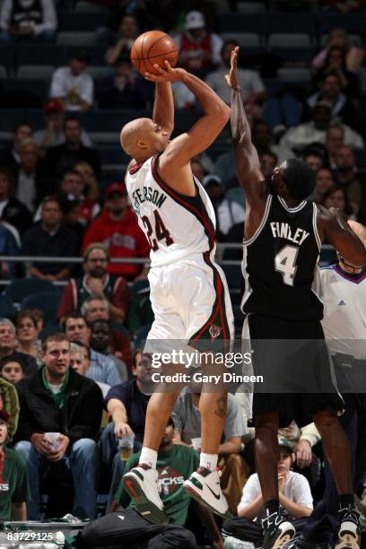 Richard Jefferson of the Milwaukee Bucks shoots a jump shot over Michael Finley of the San Antonio Spurs during the game at the Bradley Center on...