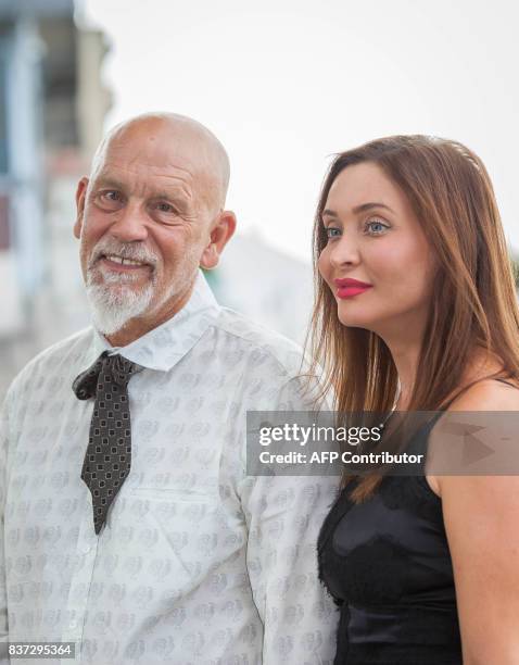 Actor and director John Malkovich, president of the jury, and Italian actress Isabella Orsini pose during a photocall at the 10th Angouleme...