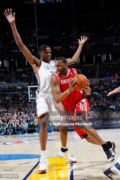 Tracy McGrady of the Houston Rockets drives toward the basket while being guarded by Kevin Durant of the Oklahoma City Thunder on November 17, 2008...