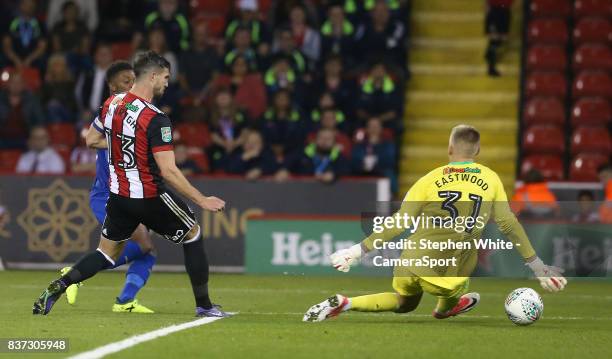 Leicester City's Demarai Gray scores the opening goal shooting past Sheffield United's Jake Wright and goalkeeper Jake Eastwood during the Carabao...