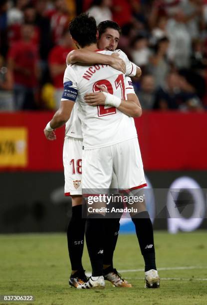 Sergio Escudero and Nicolas Pareja of Sevilla celebrate after scoring a goal during the UEFA Champions League play-off match between Sevilla and...